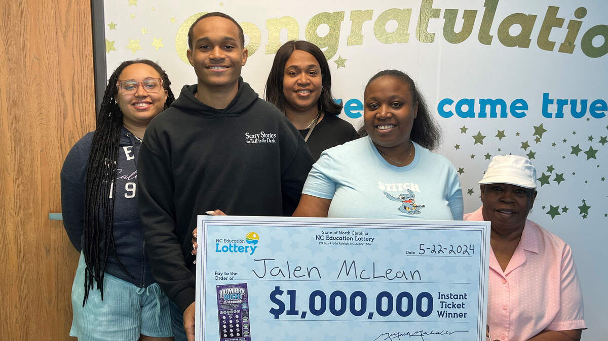 Jalen McLean poses with family members after winning a huge lottery prize.