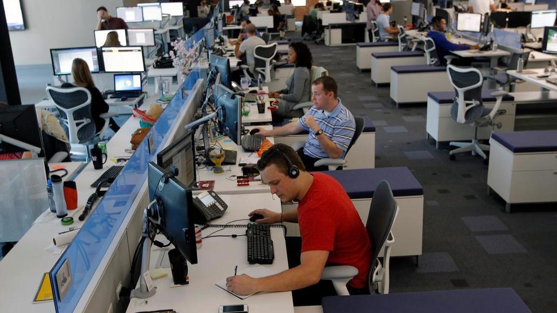 Shelby Hutchinson, foreground, and others work in the sales area inside Citrix's new office in downtown Raleigh in 2014.