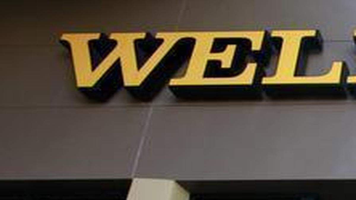 
A customer exits a Wells Fargo bank branch in Los Angeles. The Federal Reserve conducts exams to determine whether large lenders have enough capital to withstand another dire economic slump. This year, Charlotte-based Bank of America exceeded the 5 percent minimum for top-tier capital by more than it did last year, while Wells Fargo and BB&T posted lower percentages than the year before.
