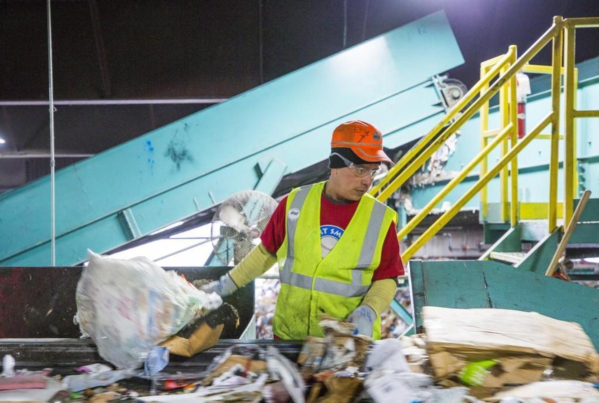 Carlos Acevedo sorts incoming materials at the Sonoco Recycling facility in Raleigh.