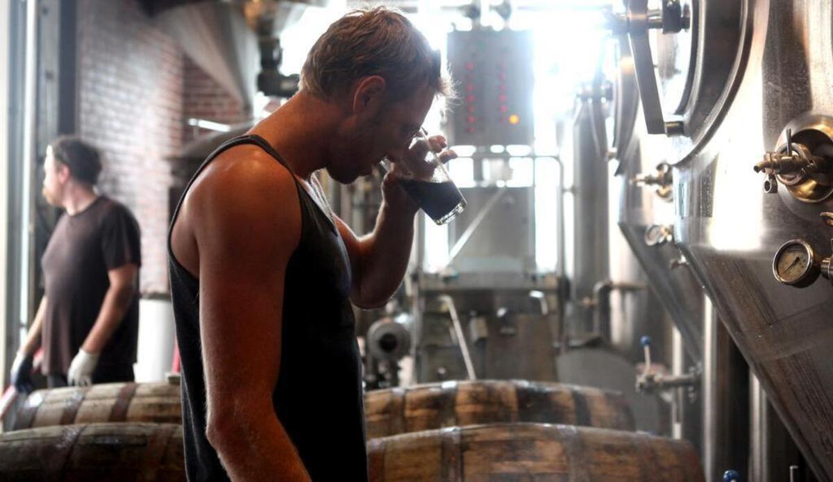 Walt Dickinson, co-owner of Wicked Weed Brewery, inspects the progress of a brewing beer on Wednesday, Aug. 21, 2013, in Asheville, NC.