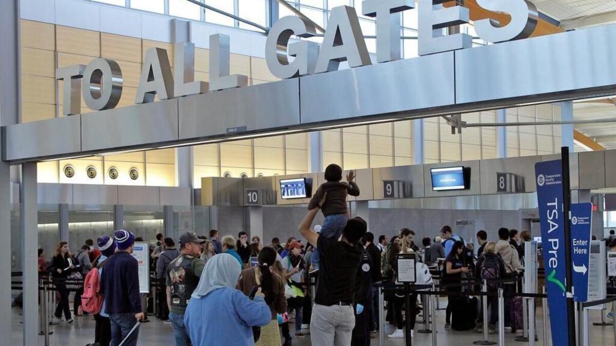 A youngster gets a boost to wave bye at Raleigh-Durham International Airport’s Terminal 2 before Thanksgiving in 2014. The Wednesday before and the Sunday after Thanksgiving are two of the busiest travel days of the years at RDU.