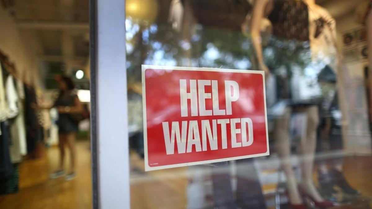 A help wanted sign is in the window of the Unika store in September in Miami, Florida.