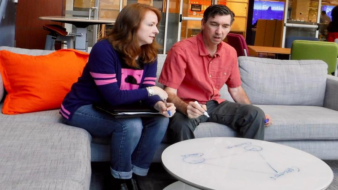 Erika Williamson and Paul Mosca brainstorm with a whiteboard table in The Frontier co-working space in Research Triangle Park. In late August, they plan on launching a website to help college students connect with each other to study.