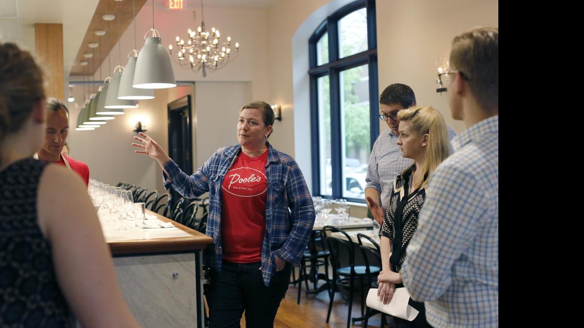 
Ashley Christensen, Poole's diner chef, talks to staff before the start of Stir the Pot with Ryan Prewitt, pictured left, Sunday, April 19, 2015 inside Christensen's newest restaurant, Death & Taxes in downtown Raleigh.
