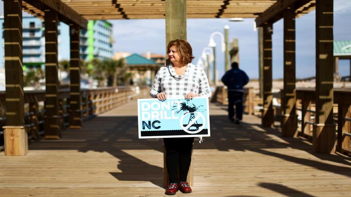 Mo Linquist holds an anti-drilling sign on the boardwalk in Kure Beach in January 2016. The Obama administration last year withdrew its plan to permit oil and gas drilling off the southeast Atlantic coast, yielding to an outpouring of opposition from coastal communities from Virginia to Georgia. But President Donald Trump has put drilling off the coast of North Carolina back in play with an executive order that calls for drilling and seismic testing in the Atlantic Ocean.