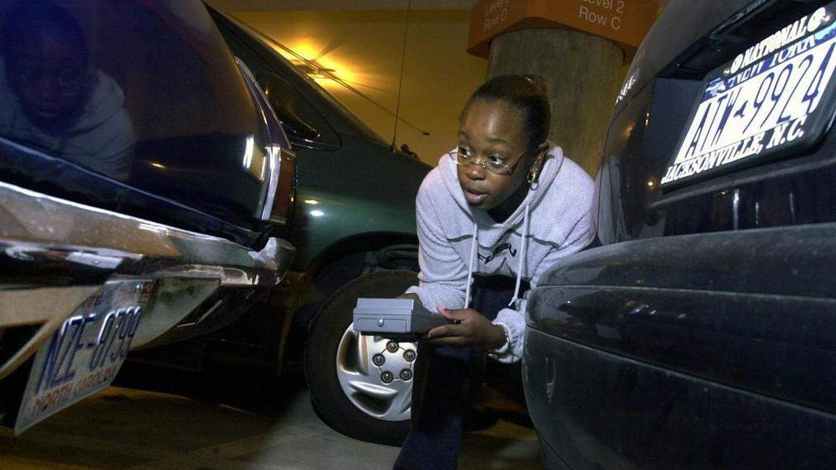 Raleigh-Durham International Airport parking employee Tanya Brown enters vehicle license numbers into a handheld computer that keeps track of which car is parked in which space in which lot. The airport conducts a census of its parking lots every night, in part so it can help travelers find their cars if they forgot where they parked.