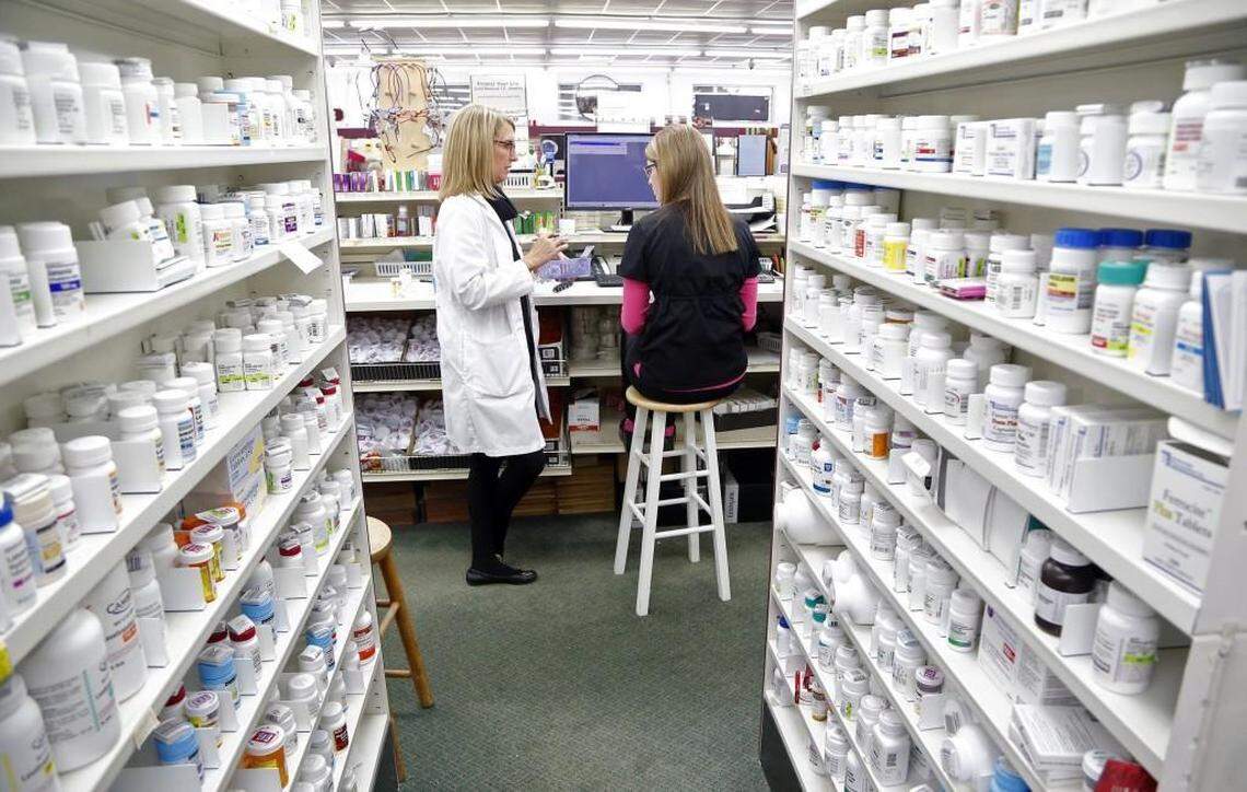 Third generation pharmacist Dr. Paige Thomas Houston, left, talks with pharmacy technician Ashlyn Hair as they work at Houston’s independent Thomas Drug Store in Dunn, NC on Jan. 20, 2016.