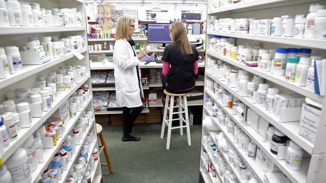 Third generation pharmacist Dr. Paige Thomas Houston, left, talks with pharmacy technician Ashlyn Hair as they work at Houston’s independent Thomas Drug Store in Dunn, NC on Jan. 20, 2016.