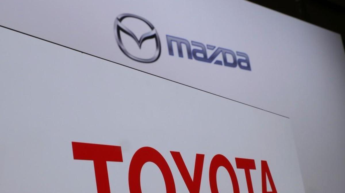 Toyota Motor Corp. and Mazda Motor Corp. logos were displayed at a news conference in Tokyo in August when the joint venture was announced.
