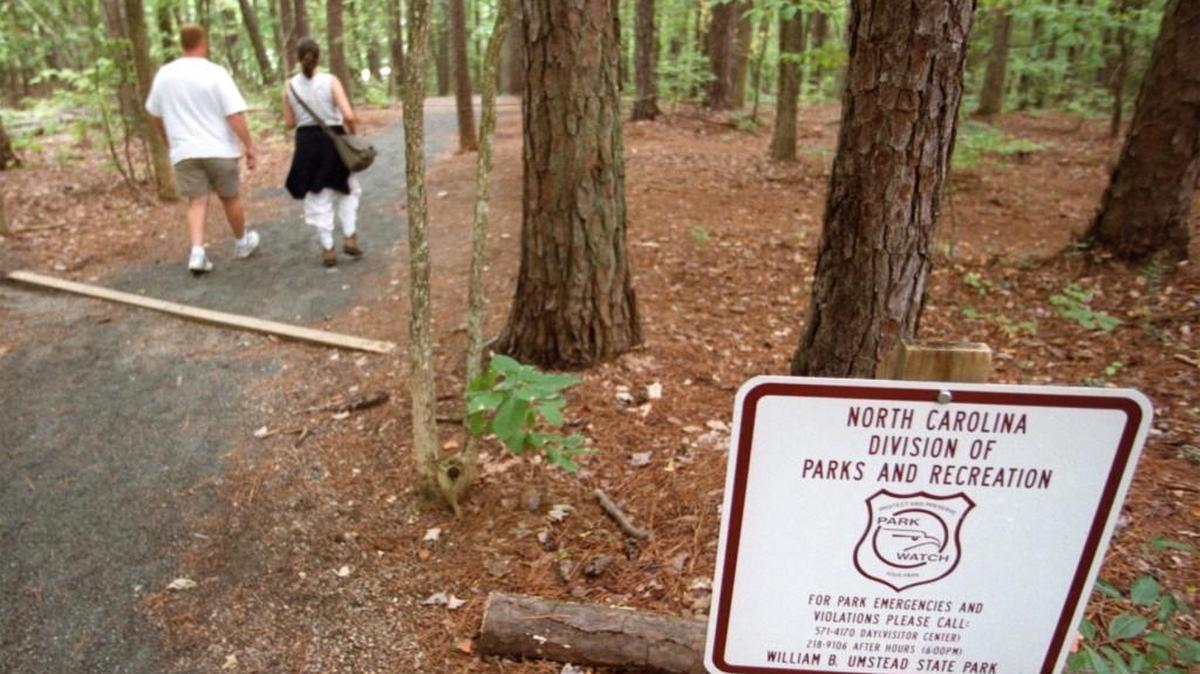 Two hikers set off into the woods at Umstead State Park. The Conservation Fund, a national nonprofit, has made the Raleigh-Durham Airport Authority an offer to buy about 105 acres between Umstead and Interstate 40 for nearly $6.5 million to preserve it as part of the park.