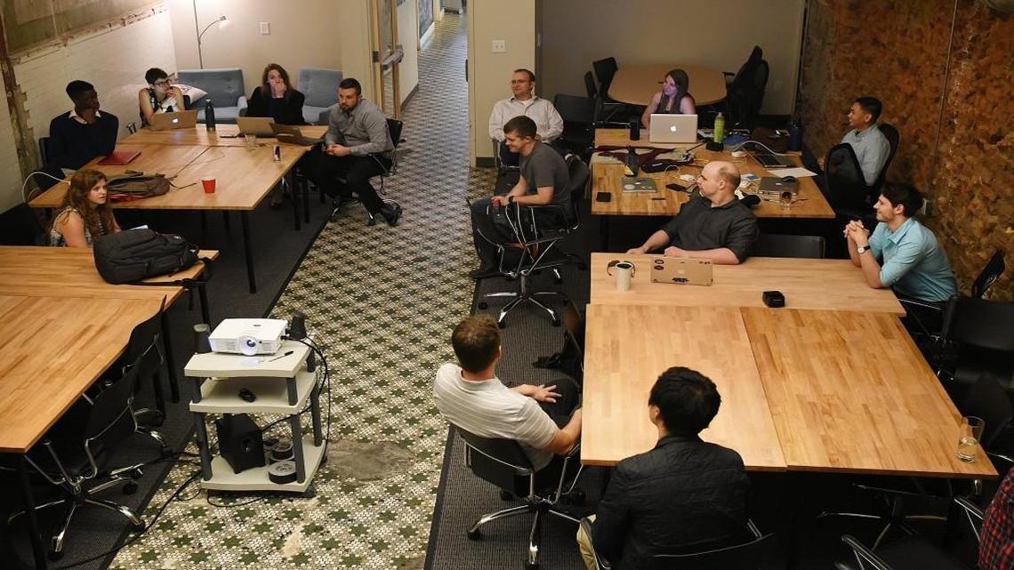 Students and faculty meet to discuss end-of-the-year presentations at The Iron Yard in Raleigh in May.