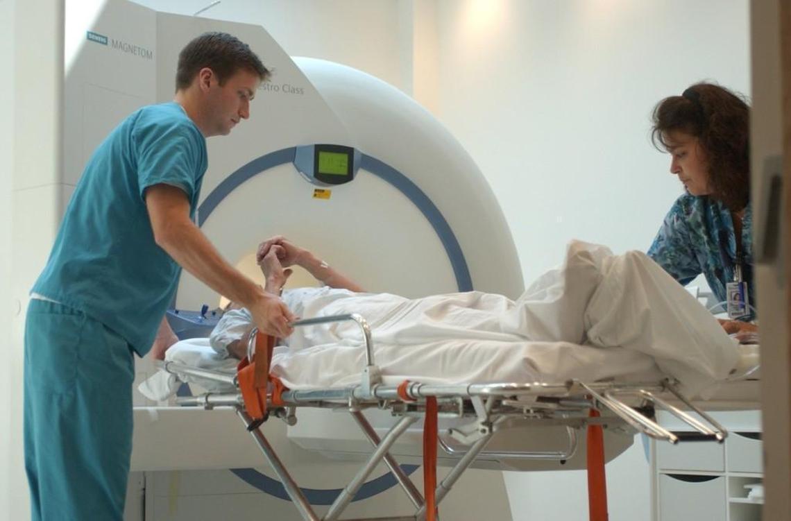 MRI technologists move a patient from a MRI scanner at Wake Medical Center.