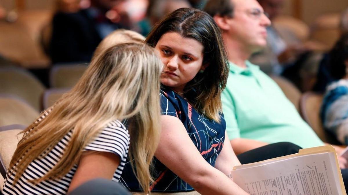 Tonya Baker Nelson, executive director of Hand of Hope Pregnancy Centers, left, talks with Calla Hales, director of A Preferred Women's Health Center, center, during a comment period in the municipal building in Raleigh on June 21, 2016.