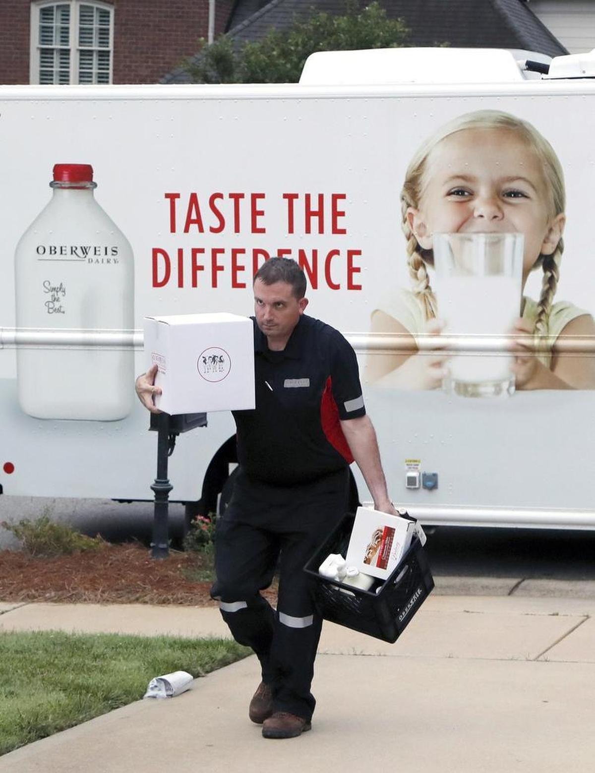 Milk, ice cream, and other products are delivered by milkman Ben Ridgeway to a customer's doorstep on June 22, 2017 as he makes his rounds in Cary and Apex. Oberweis Milk Home Delivery, based in the Chicago area, expanded to the Triangle in May, hoping to bring back a service that was commonplace years ago.