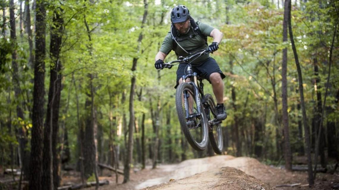 Shawn Troy of Cleveland rides the popular mountain bike trails on RDU Airport Authority land leased by Wake County for Lake Crabtree County Park on Oct. 8, 2014.