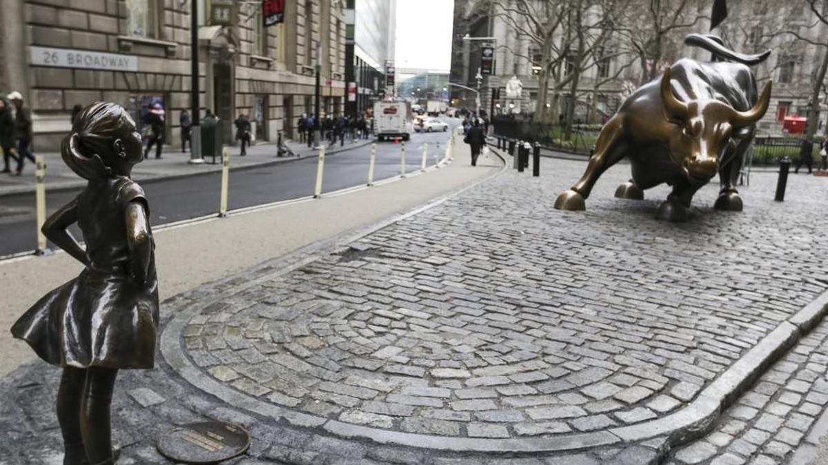 A bronze statue of a defiant girl faces "Charging Bull" in the Financial District of New York on International Womens Day, March 8, 2017. State Street Global Advisors, a unit of State Street Corp., installed the Kristen Visbal statue in front of Arturo Di Modica's iconic charging bull by as part of its new campaign to pressure companies to add more women to their boards.