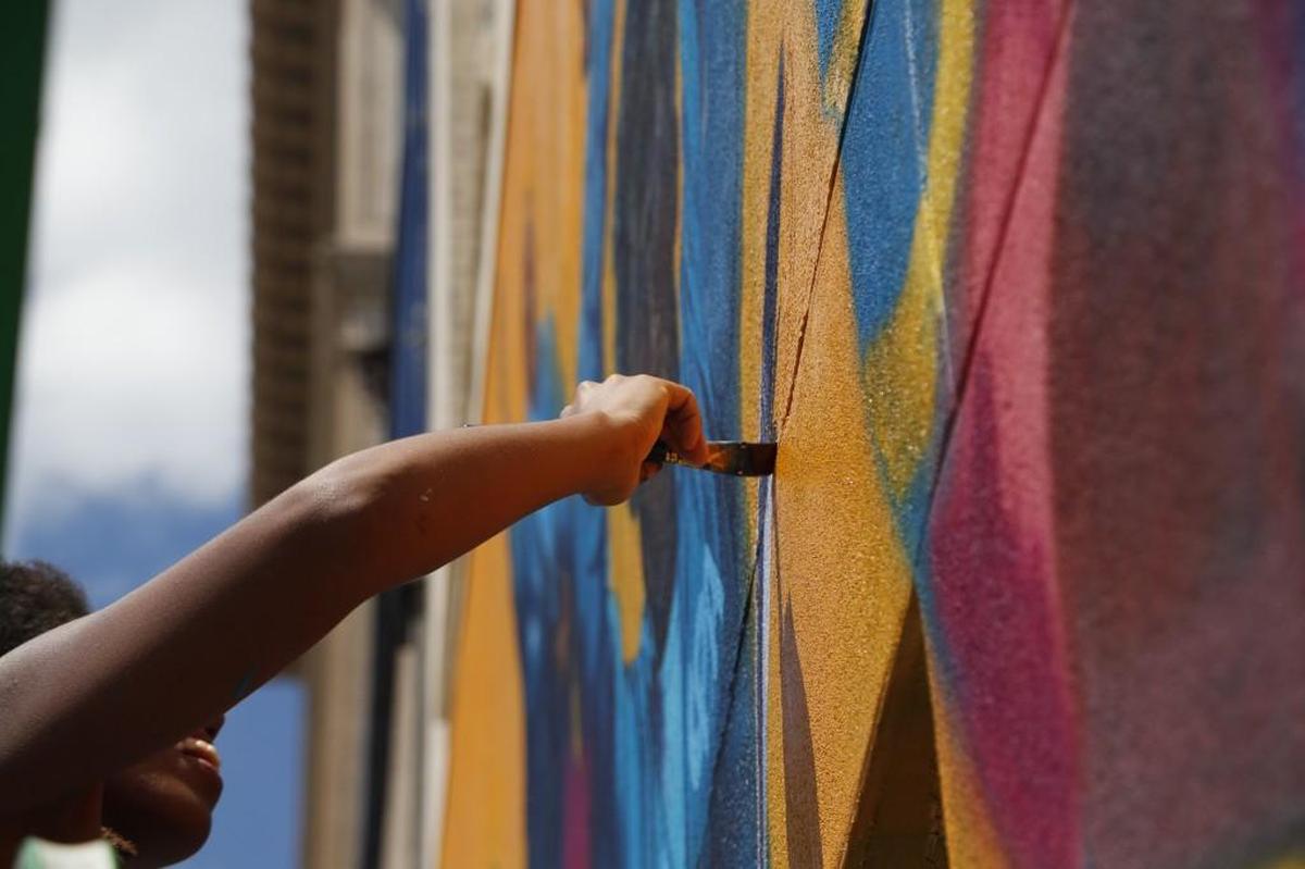 Artist Dare Coulter paints a mural of protestors as part of an ACLU commission on the back of a building on Salisbury St. in Raleigh, NC on June 27, 2017. It is slated to be unveiled Wednesday, June 28, 2017.