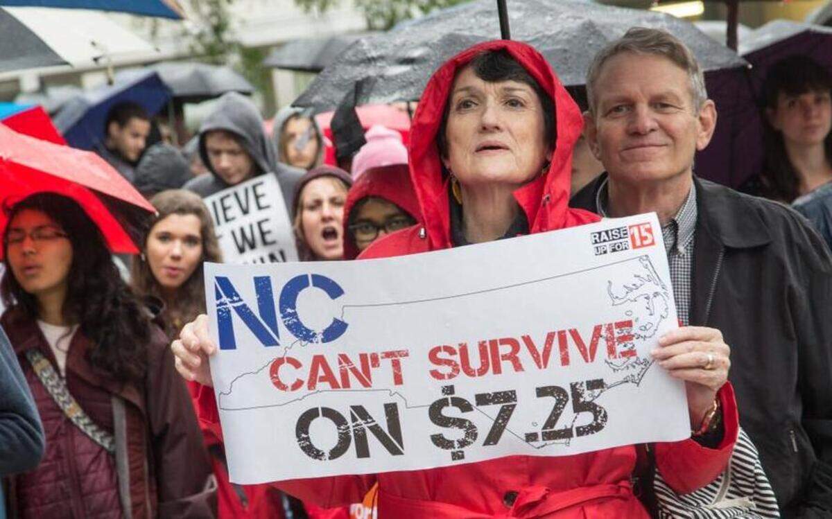 
Linda Burton of Raleigh demonstrates with hundreds in support of a higher minimum wage during a rally Wednesday, April 15, 2015 at Shaw University in Raleigh.
