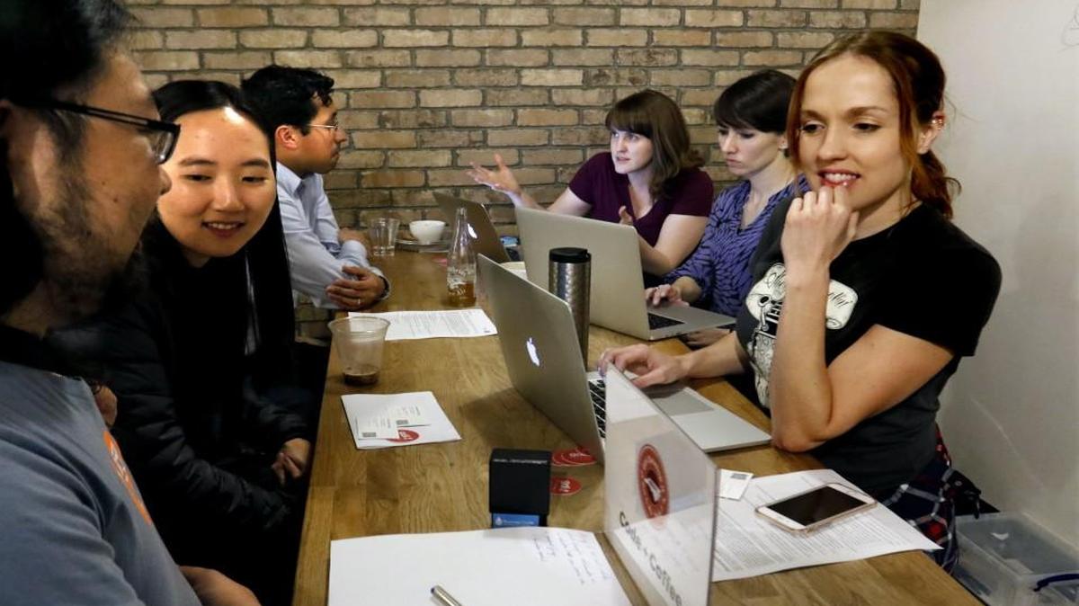 From left, Chris Jester-Young, So Young (no relation), Gabe Casalett, , Barbara Carradini, Elisha Schwabauer and Janel Sheehan, all who have an interest in web design and development meet Tuesday evening, March 8, 2016 in a north Raleigh, NC coffeehouse for the monthly Raleigh group meeting of Code + Coffee. The monthly Code + Coffee meetings are sponsored by the RDU chapter of Girl Develop It, giving web design/developers an opportunity to network with fellow members allowing them to seek help with coding and software projects. Schwabauer, the organizer for the Raleigh meeting says there are group meetings in Chapel Hill, Durham, Carrboro and Raleigh, with a majority of the group of nearly 1,800 members in the Durham area. Code + Coffee is focused on demystifying computer coding for adult women.