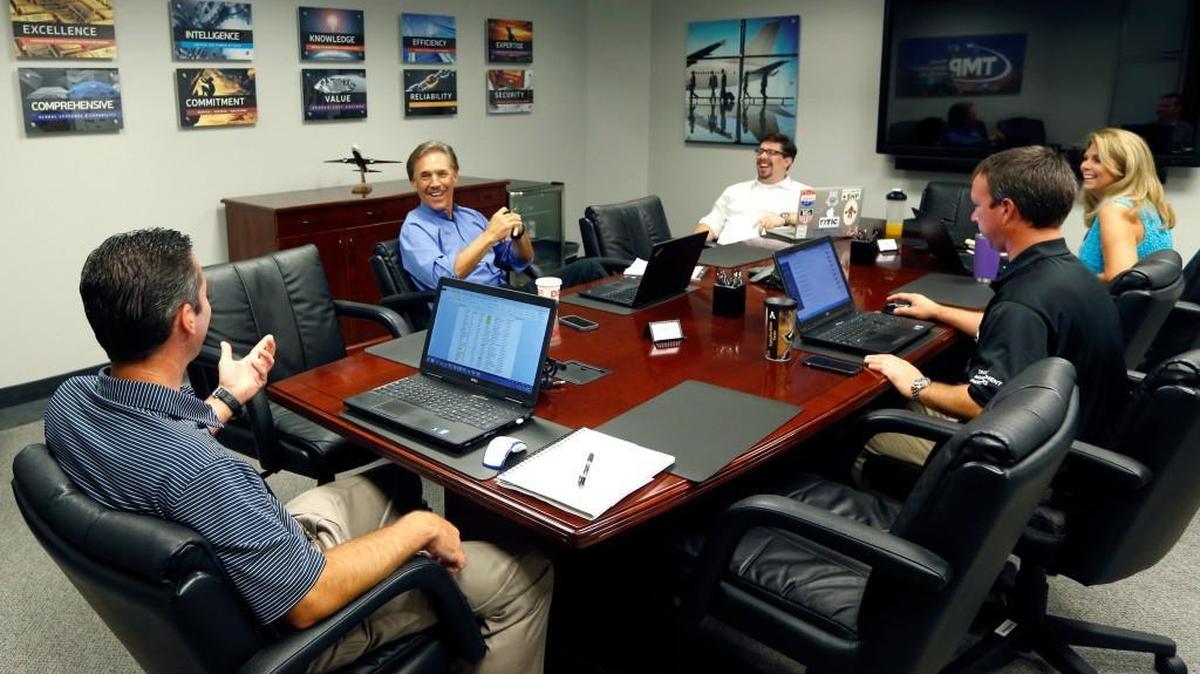 Clockwise from left, John Lewis III (striped shirt), Kevin Brown, Josh Lewis, Aprel Buonpane Gandy and Jason Lewis talk during a sales team meeting at Travel Management Partners' office in Raleigh Tuesday, August 30, 2016.