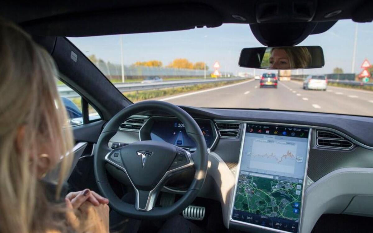 An employee drives a Tesla Motors Inc. Model S electric automobile, equipped with Autopilot hardware and software, hands-free on a highway in Amsterdam, Netherlands.