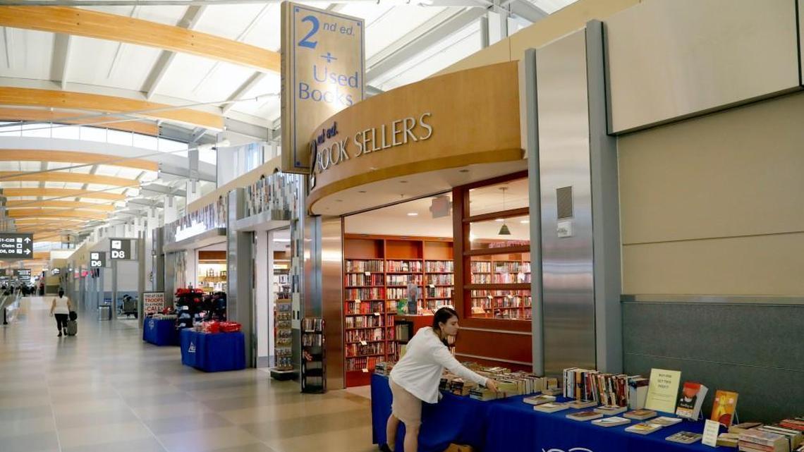 2nd Edition Book Sellers on the concourse of Terminal 2 at RDU Airport is closing at the end of December as owners Karen and Walter High retire. Here employee Ashlyn Tookey arranges some books for sale on a table outside the store.