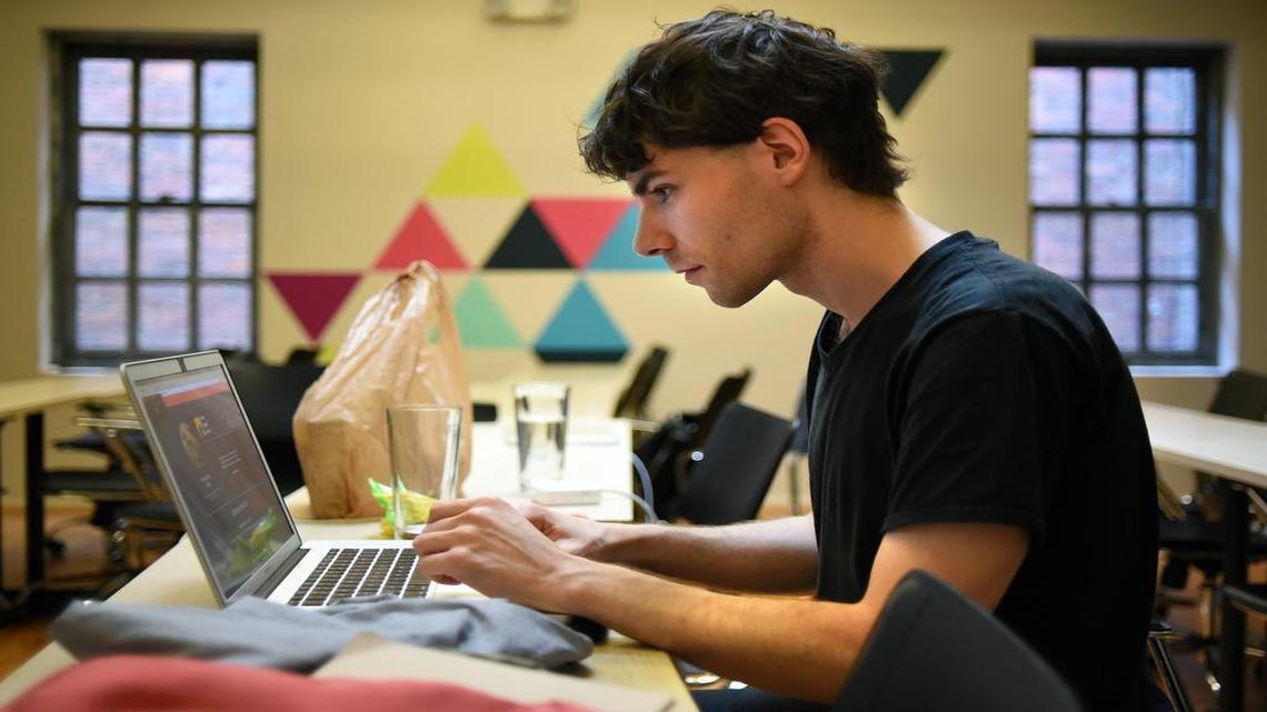 Ellis Anderson, 29, of Greensboro, works on his part of an end-of-class presentation at The Iron Yard in Raleigh, N.C., Thursday, May 18, 2017. Anderson and other students are taking part in a coding boot camp, a 12-week program to fast track their careers in the tech field. Anderson is taking the user interface design course. "It's been an intense three months. Every day is busy, you can't have a full time job unless you don't like to sleep,” Anderson says. “There are lectures in the morning, afternoon lab time then homework at night."
