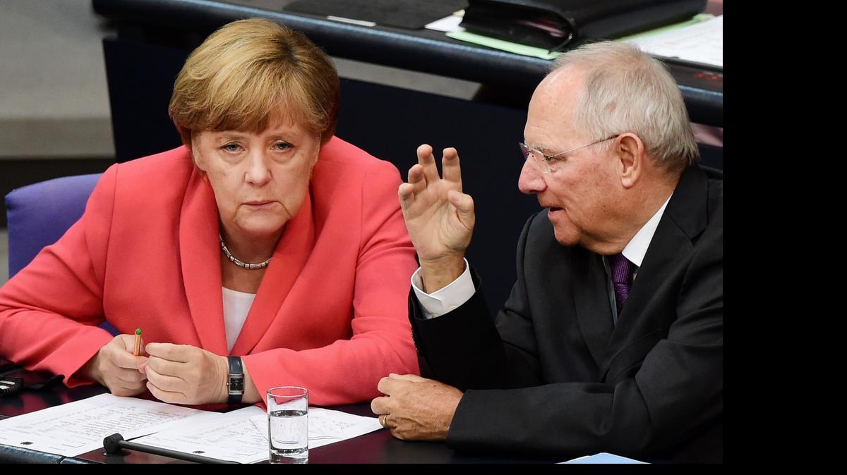 
German Chancellor Angela Merkel (L) confer with finance minister Wolfgang Schaeuble during a debate in the Bundestag, the German lower house of parliament in Berlin on July 17, 2015. German lawmakers will vote during todays sitting in the Bundestag on entering into negotiations on the new aid package for Greece. 
