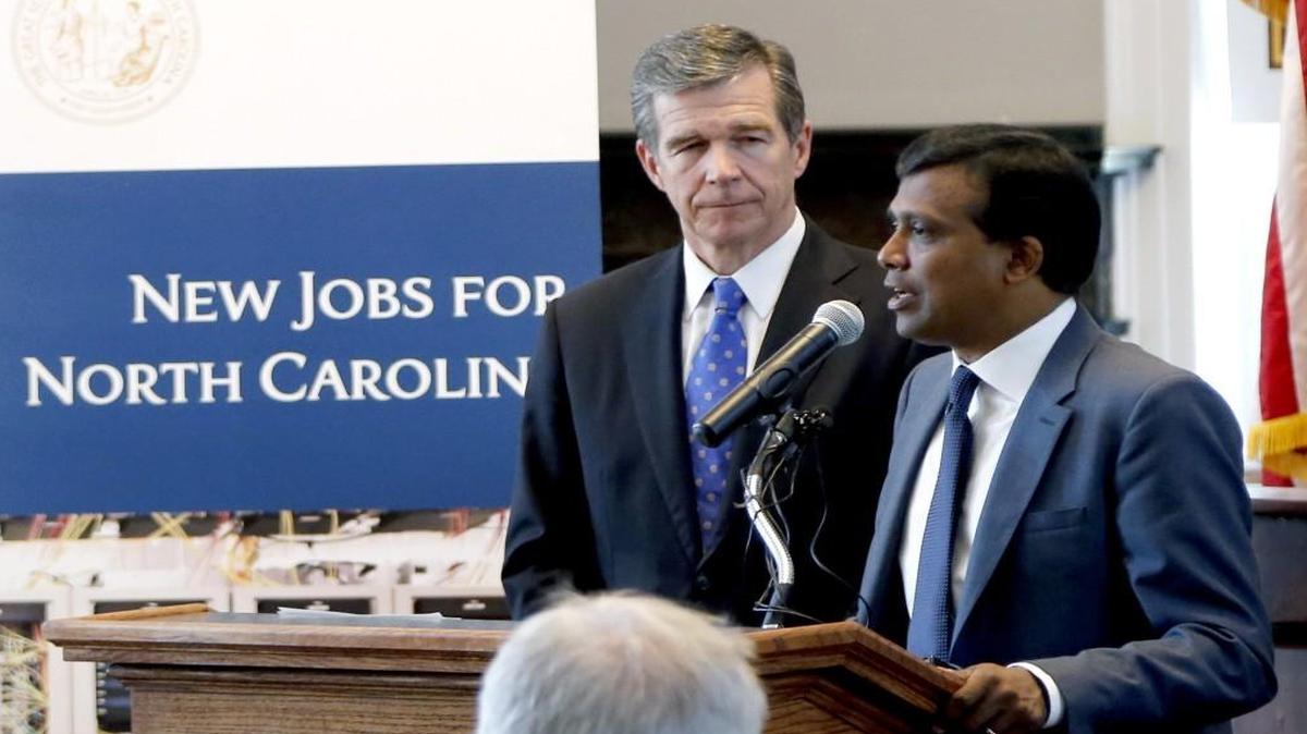 Gov. Roy Cooper, left, and Infosys president Ravi Kumar in July announcing that the tech company plans to open a facility in the Triangle.