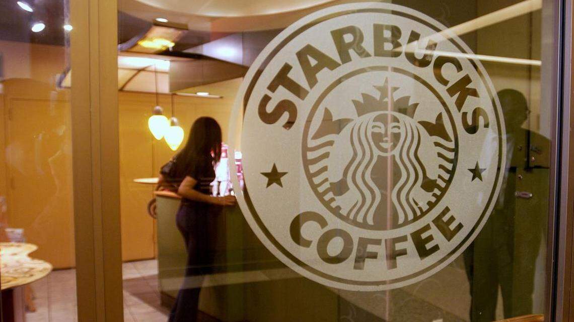 
A customer waits for her purchase at the counter of a Starbucks Coffee in New York.
