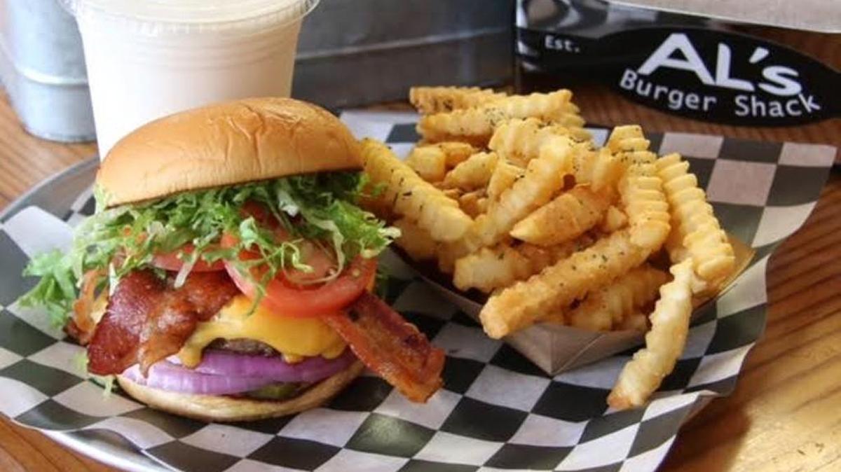 Husband and wife Al and Mel Bowers opened Al’s Burger Shack in Chapel Hill in 2013, and it’s grown into a Franklin Street destination, serving burgers griddled in the roadside tradition, crispy crinkle cut fries and milkshakes made from Maple View ice cream.