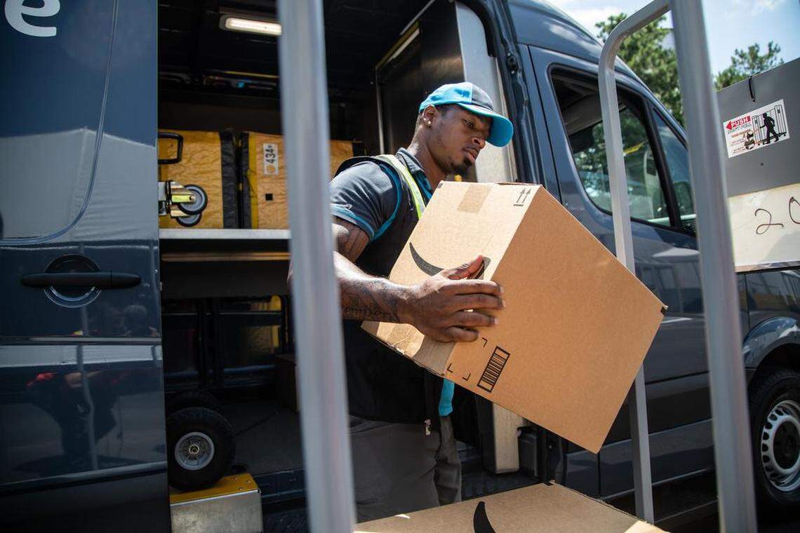 An Amazon Delivery Service Partner driver loads packages at new Amazon facility in Durham Monday, July 2 2019.