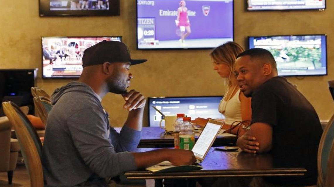 
Left foreground, Choptix startup CEO Deon McCormick and friend LeVaughn Stevenson of the Windsor Circle startup talk briefly in The Vault, the converted bank vault area with flat screen TVs Wednesday, September 9, 2105 in the American Underground @ Main basement.
