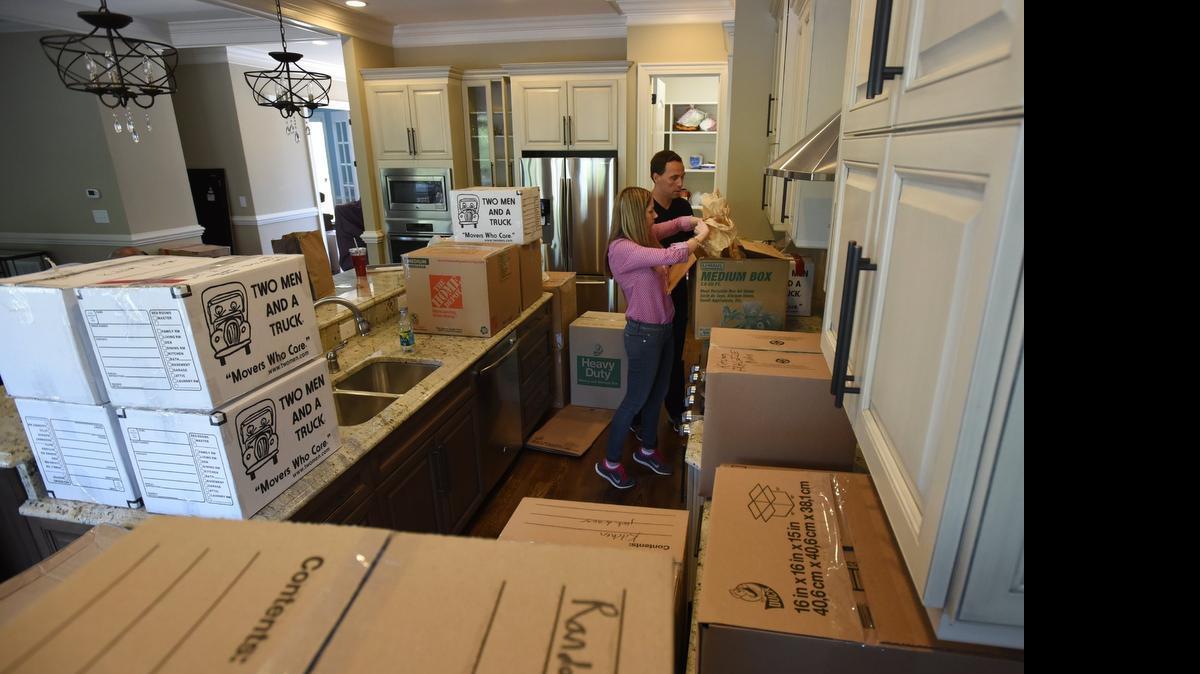 
Angie Cole and her fiancé David Padilla unpack boxes in the kitchen of their new home in Raleigh, NC , Friday, April 24, 2015. They were combining households in preparation for their marriage and were transferring their possessions to their new 5000+ square foot home. 

