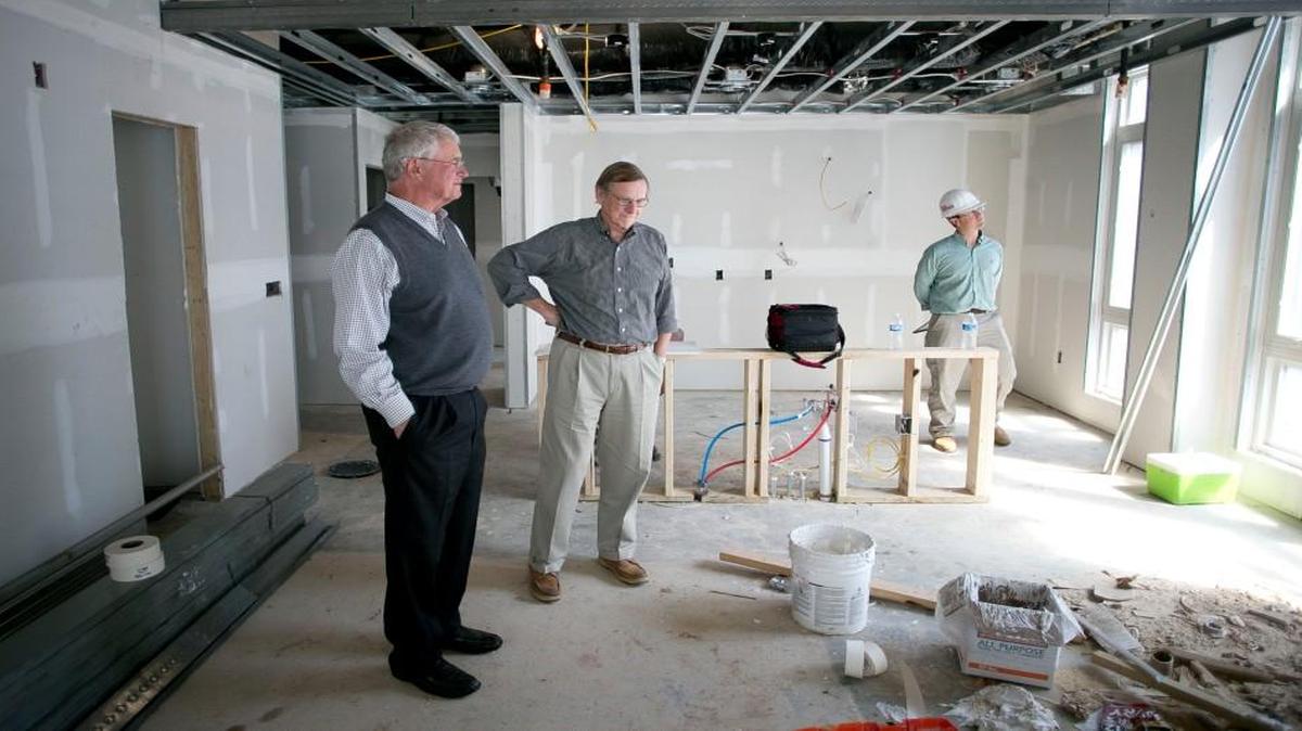 From left, investor Smedes York. developer Roland Gammon, and Roland Maurer of Sigmon Construction look over one of the condominiums under construction at 1300 St. Mary’s Street in Raleigh on Wednesday. Gammon of White Oak Properties is converting the former five story office building at the corner of St. Mary's and Wade Avenue into residential condominiums, complete with a work out facility and outdoor pool.