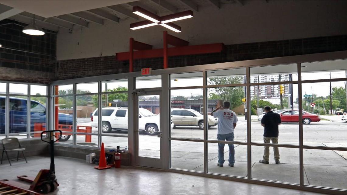 Traffic on Peace Street passes near the site of a developing commercial property Friday at the corner of West and Peace streets in northwest downtown Raleigh. The former lighting store, owned by the Lundy Group at 500 West Peace Street, is being developed for a tech company slated to occupy the building this summer.