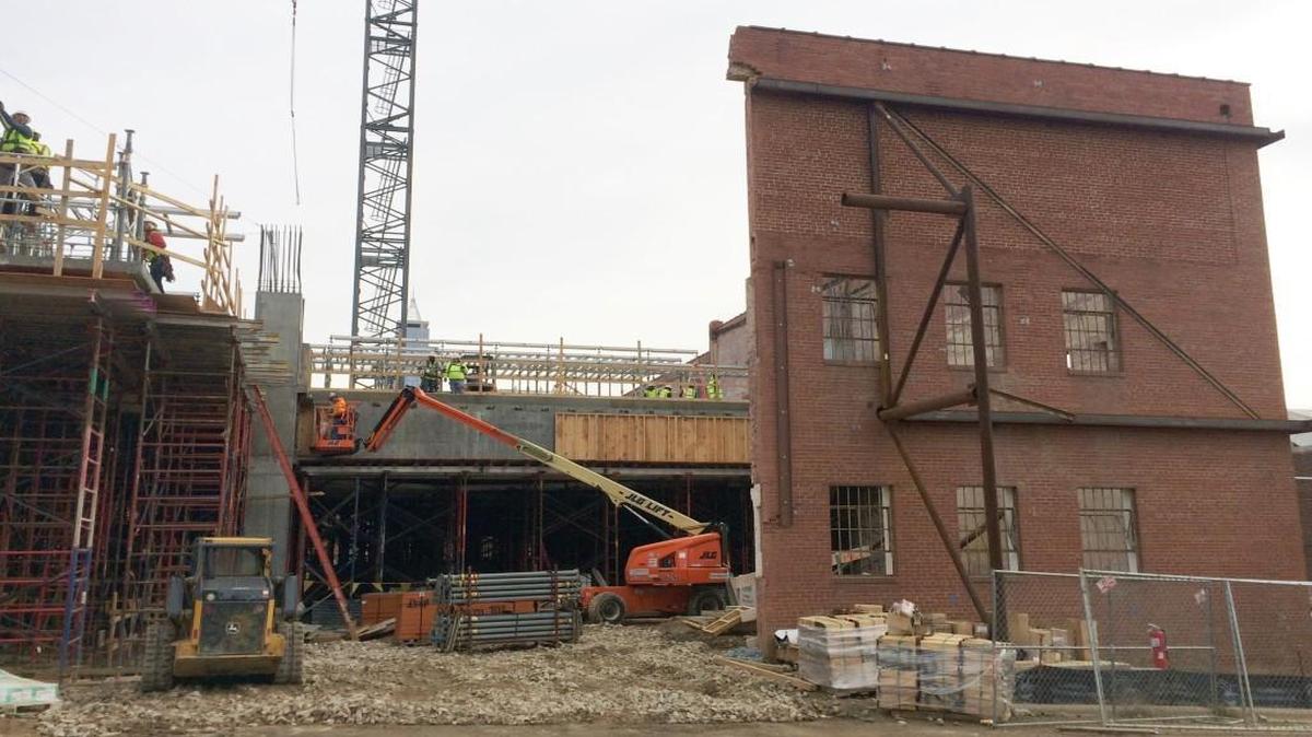 The Dillon, a 17-story office building, is being built within the walls of an old Dillon Supply Co. warehouse in downtown Raleigh. The project was made possible by a brownfields agreement with the state, which allowed the developer, Kane Realty, to clean up pollution on the site only as much as was needed to make the site usable again.