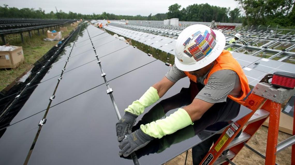 In this 2016 photo, a worker secures solar modules into place in Lumberton, NC where Strata Solar, now Strata Clean Energy, built a solar farm on a 43-acre site. As of Dec. 2021, North Carolina ranked fourth in the nation in installed solar capacity.
