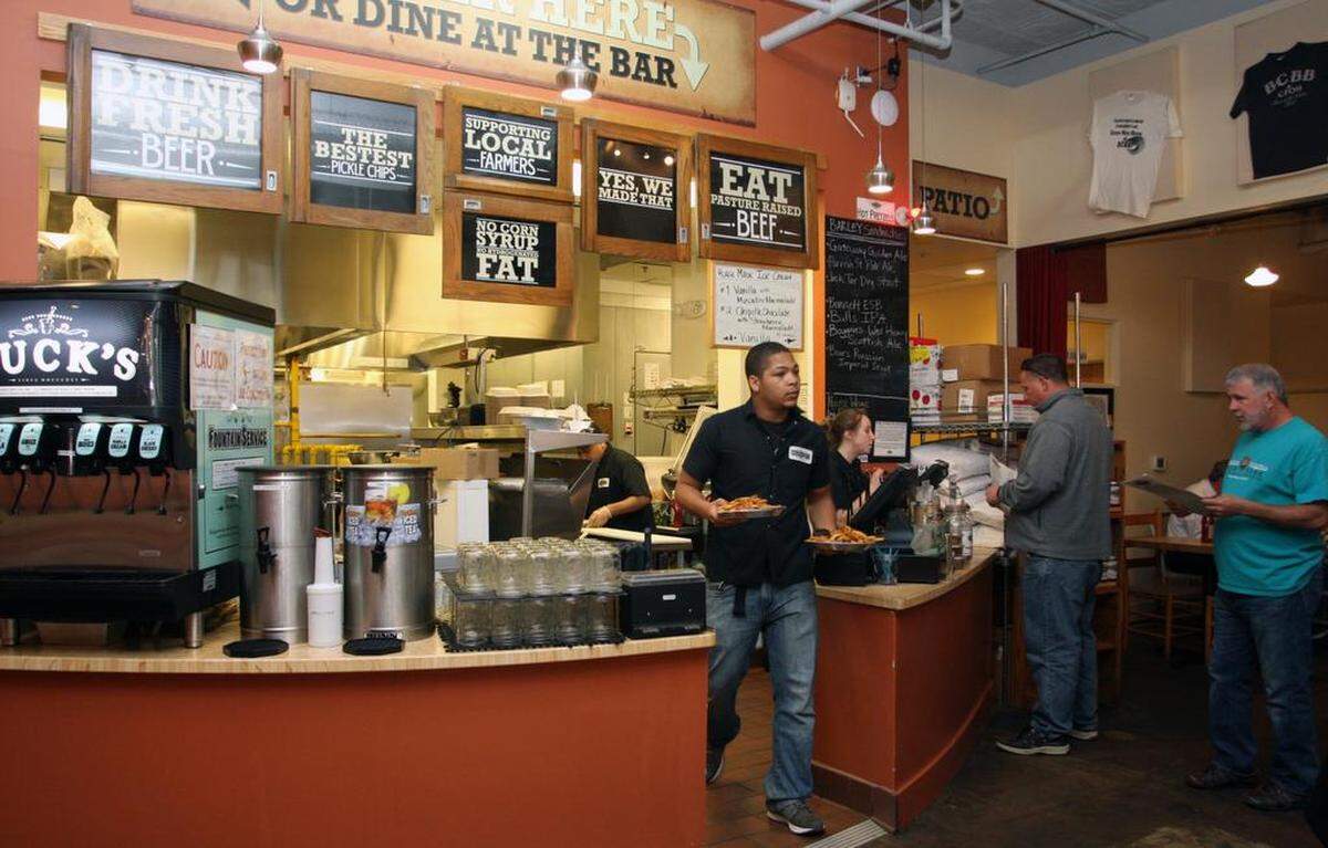 Shaquawn Grant runs food at Bull City Burger and Brewery in Durham o Thursday, April 16, 2015. 
