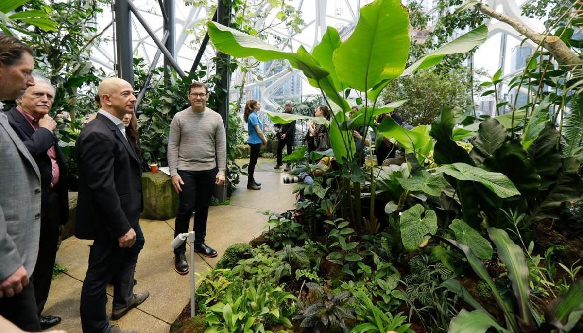 Jeff Bezos, third from left, the CEO and founder of Amazon.com, takes a walking tour of the Amazon Spheres, three plant-filed geodesic domes that serve as a work- and gathering place for Amazon employees, following a grand opening ceremony, Monday, Jan. 29, 2018, in Seattle.