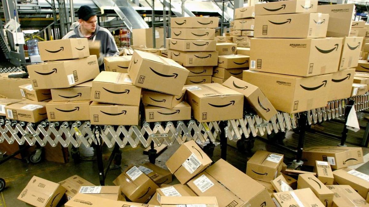 A worker sorts boxes before loading them onto trucks for shipping at Amazon’s fulfillment center in Nevada.