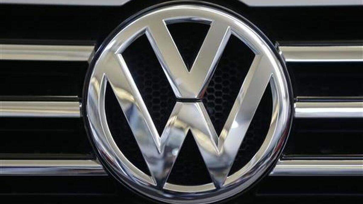 FILE - In this Feb. 14, 2013, file photo, the Volkswagen logo is seen on the grill of a Volkswagen on display in Pittsburgh. Volkswagen would repair or buy back polluting vehicles and pay each owner as much as $10,000 under a $14.7 billion deal the car maker has reached to settle lawsuits stemming from its emissions cheating scandal, a person briefed on the settlement talks said Monday, June 27, 2016.