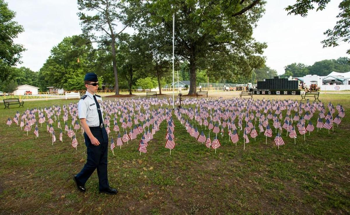 Cadet Lieutenant Jonathan Sellers holds vigil at the Field of Flags, a memorial installment at the Freedom Balloon Fest in Fuquay-Varina, in 2017. This year, the balloon festival will not be held, but the Field of Flags will. Its location this year is American Legion Post 116, 6400 Johnson Pond Road.