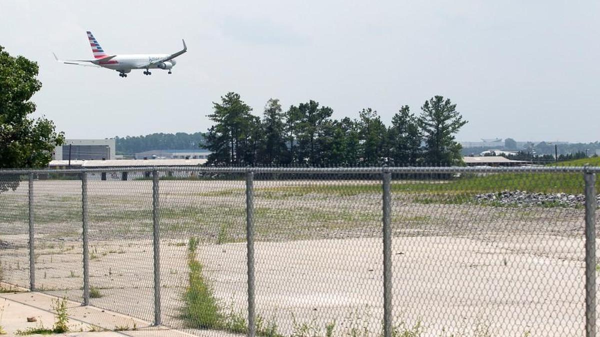 An American Airlines jet approaches Raleigh-Durham International Airport for landing above the fenced site of the former Ward Transformer Co. in this file photo from 2014. The airport may need to acquire part of the Ward Transformer property when it builds a new runway on the airport’s west side in the coming years.