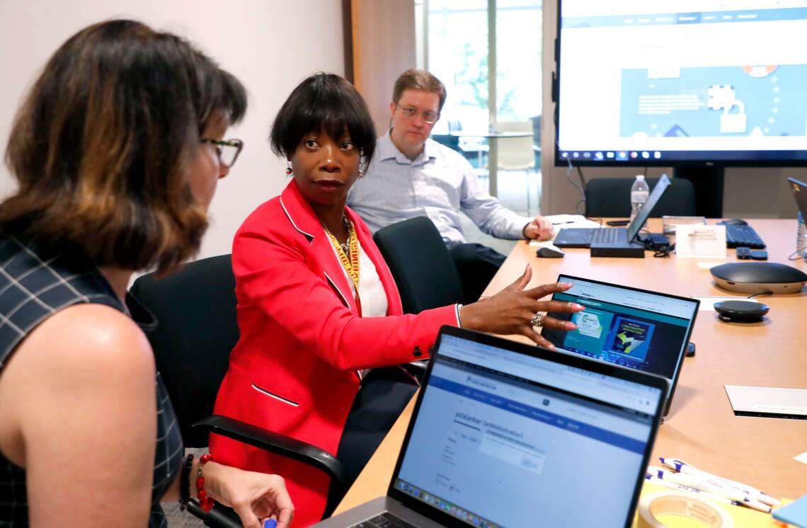 Maria Thompson, center, the State Chief Risk Officer of North Carolina, talks with Elena Talanker with Digital Solutions, left, while participating in a workshop on changes that can be made to the state’s cybersecurity website at the Innovation Center in Raleigh, N.C., Thursday, July 18, 2019. On the right is Michael McCray, IT Security and Compliance Specialist.