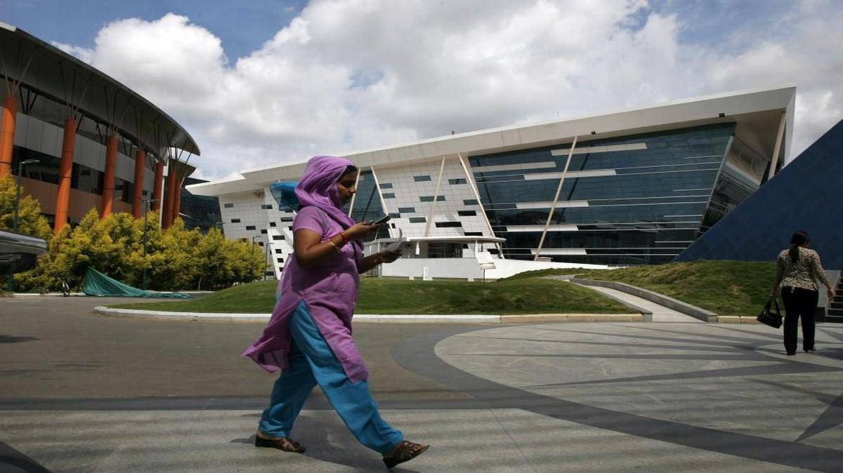 Employees walk around the Infosys campus in Bangalore, India. The company is set to announce its Wake County location Tuesday, Sept. 12.