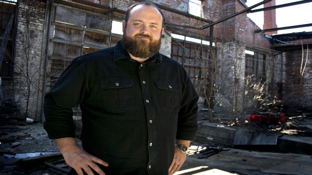Jason Queen of Raleigh poses at the Carolina Coach Garage and Shop (or Stone’s warehouse) on East Davie Street in downtown Raleigh  on Wednesday, March 2, 2016.