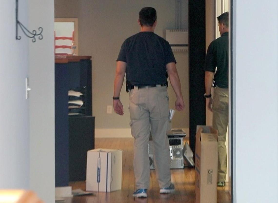 FBI agents gather evidence inside VisionQuest Wealth Management on the 100 block of East Hargett St. in downtown Raleigh, NC, on July 12, 2017. The business was raided by federal agents Wednesday.