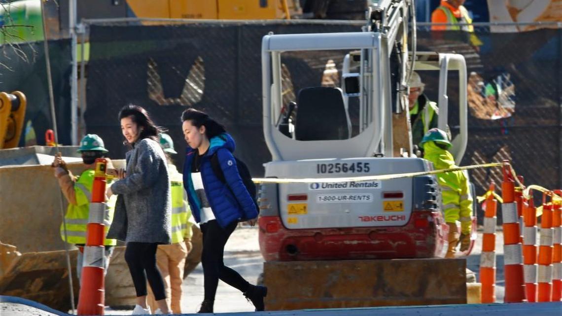 A construction company crew works in Chapel Hill last year to connect a new waterline to a mixed-use project on West Franklin Street.